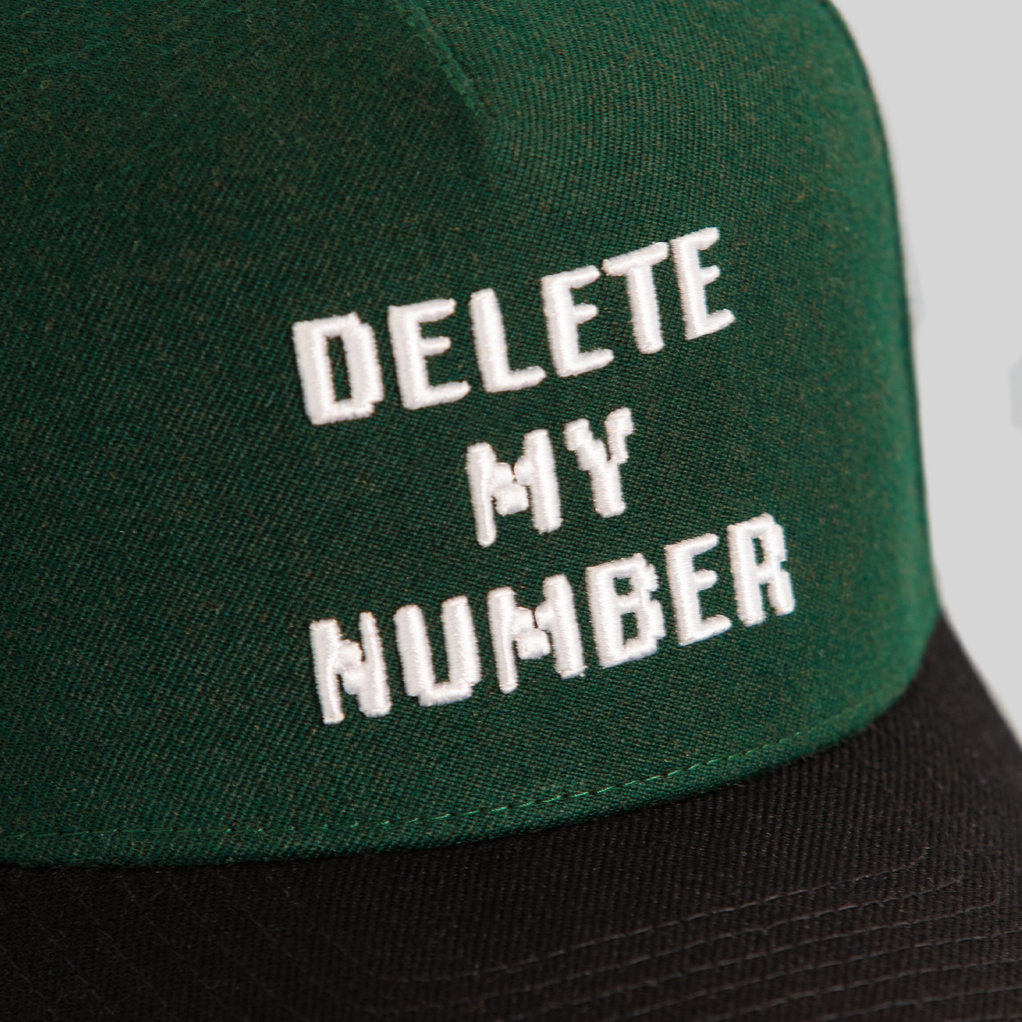DELETE MY NUMBER EMERALD BLACK WOOL TRUCKER