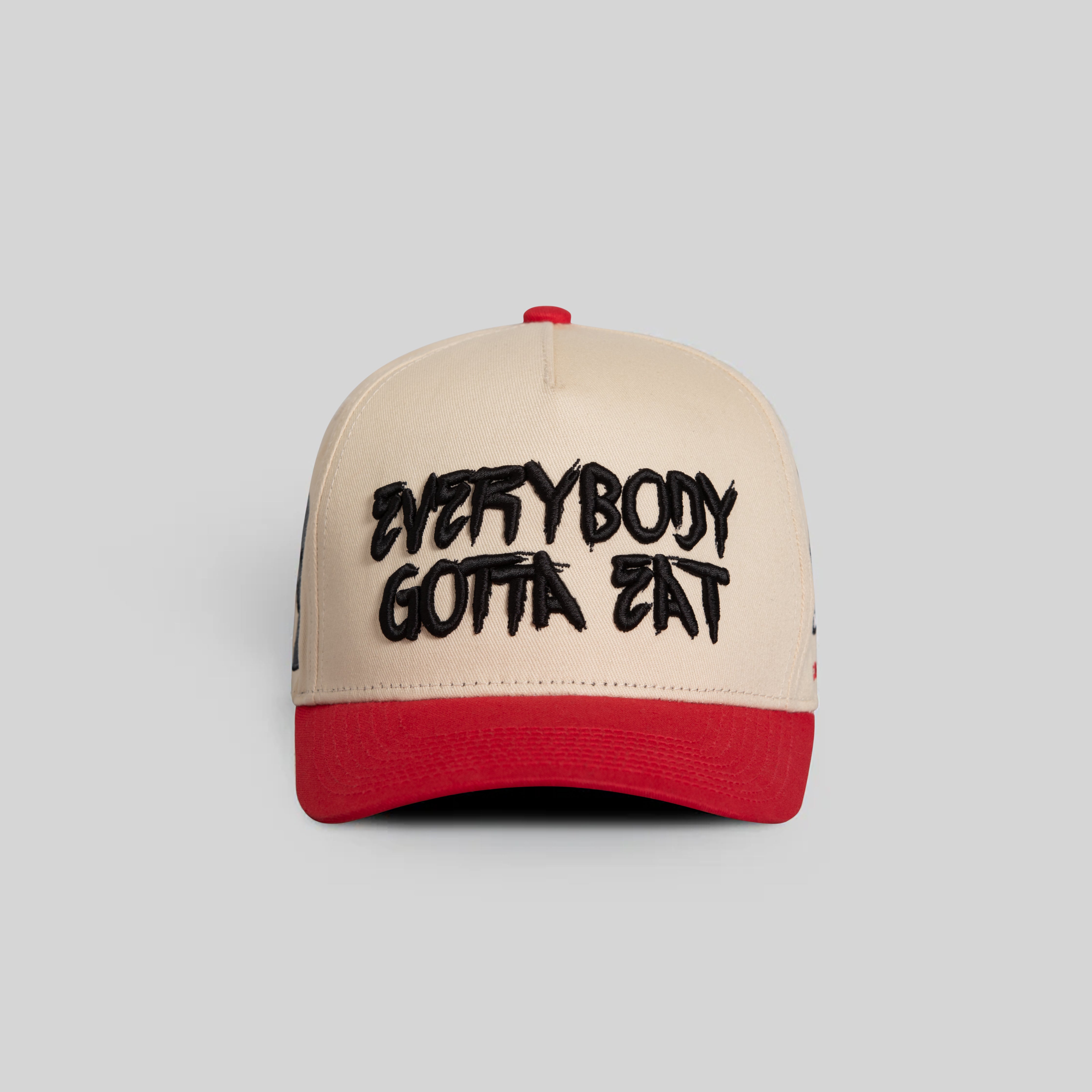 EVERYBODY GOTTA EAT SAND RED TWILL TRUCKER