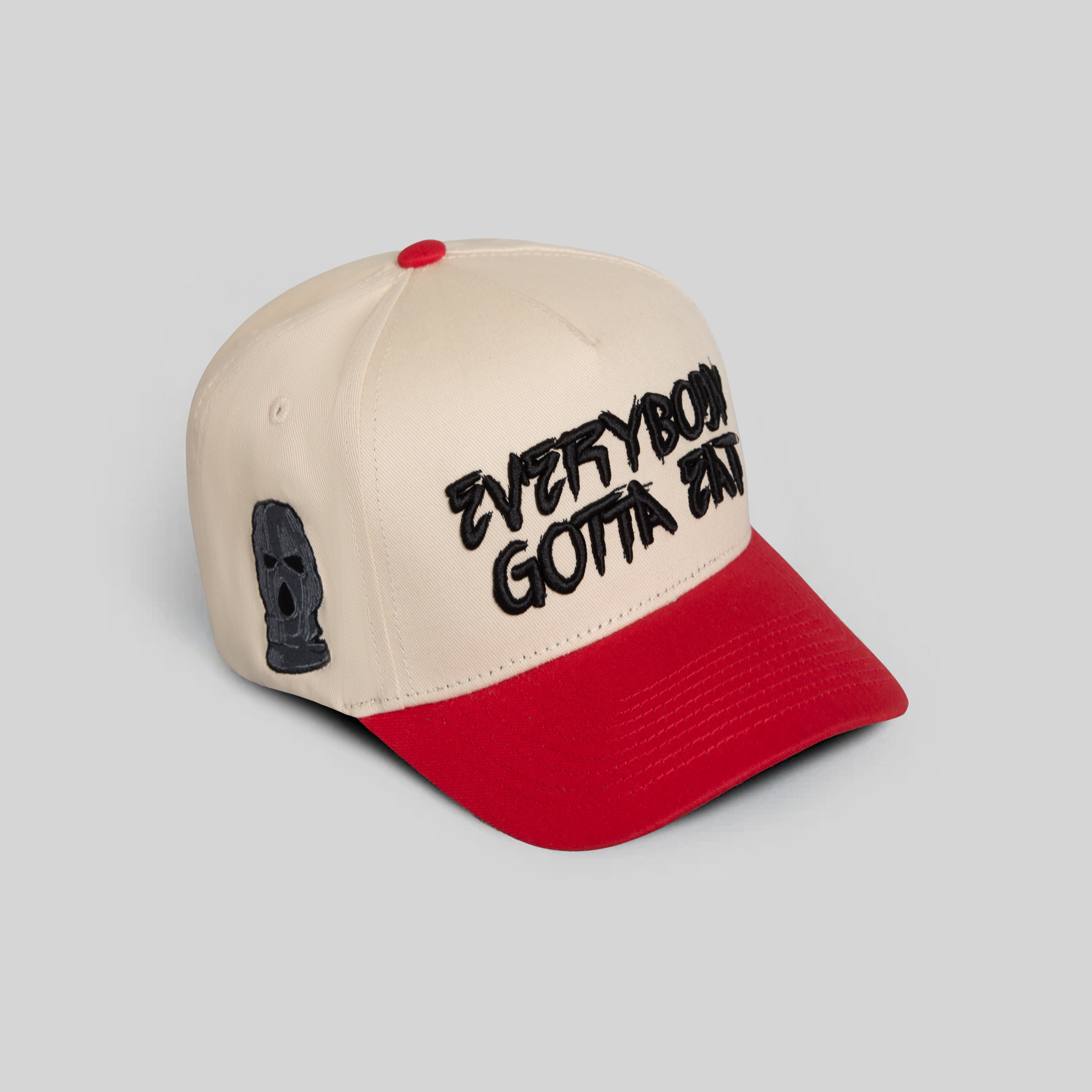 EVERYBODY GOTTA EAT SAND RED TWILL TRUCKER