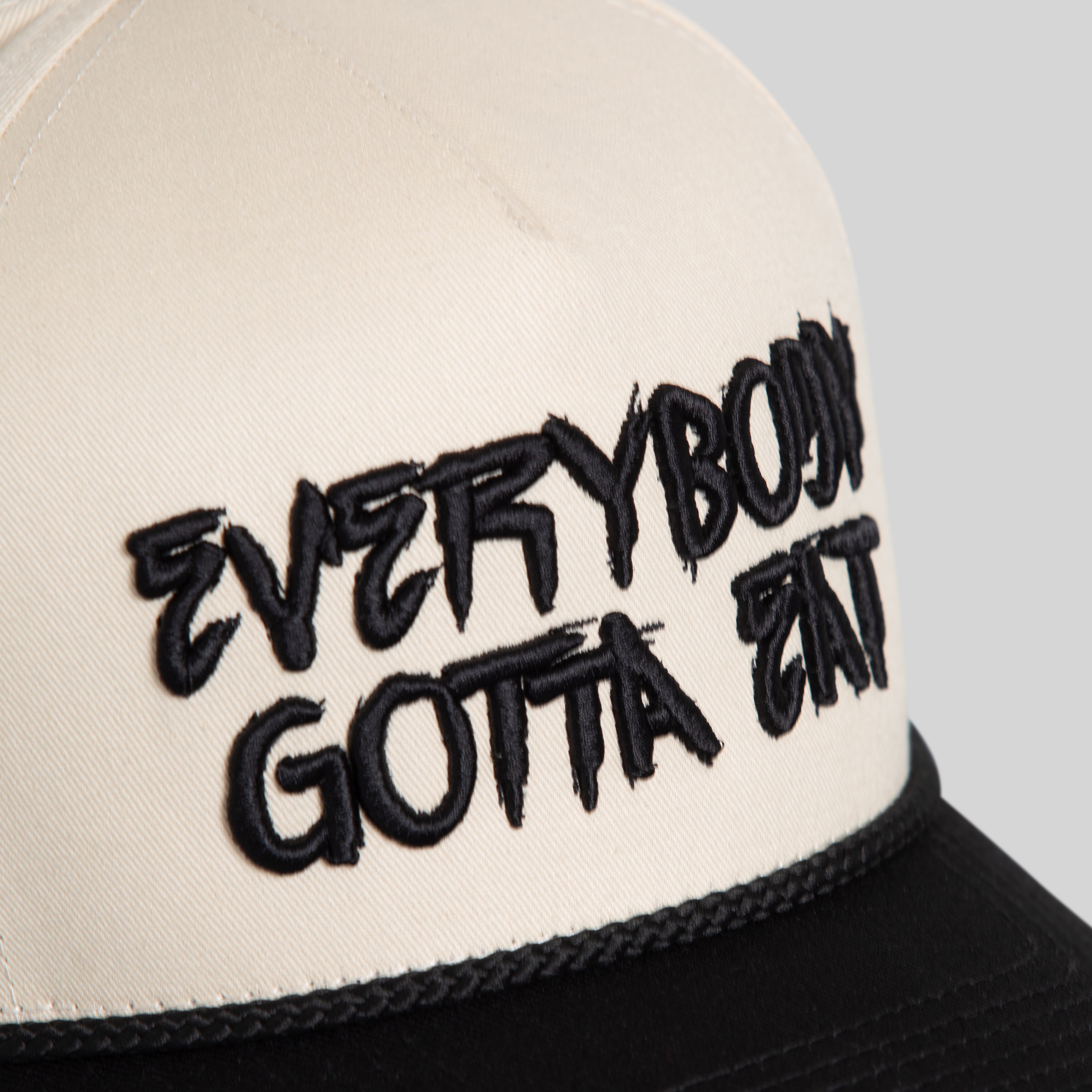 EVERYBODY GOTTA EAT SAND BLACK TWILL TRUCKER