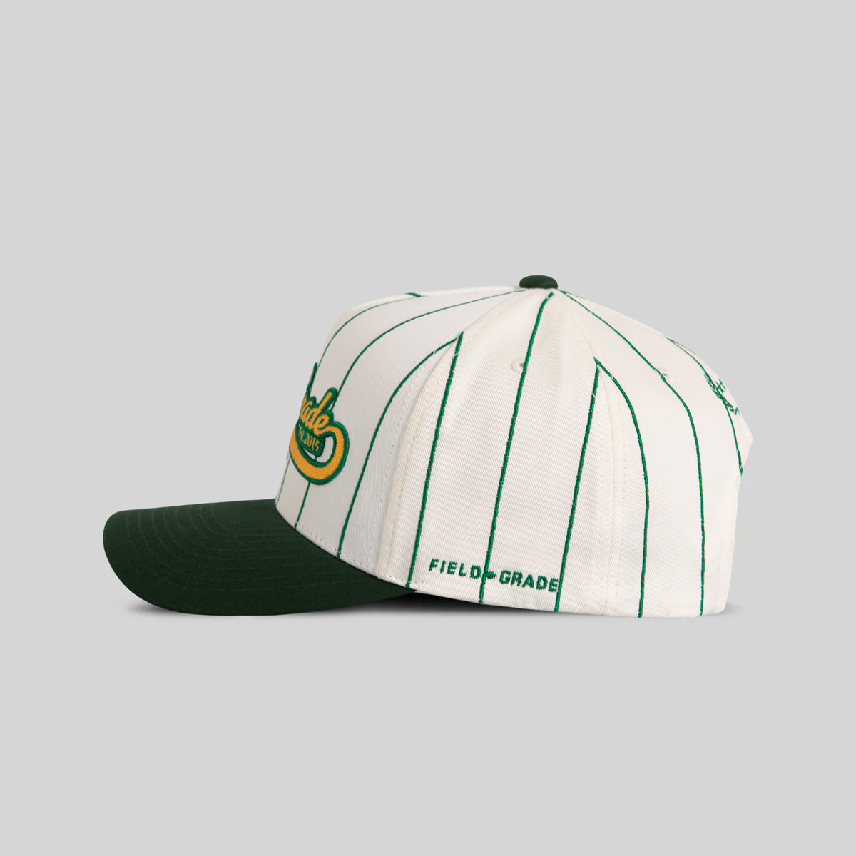 FIELD GRADE COLLEGIATE PINSTRIPE OFF WHITE EMERALD GREEN TWILL TRUCKER