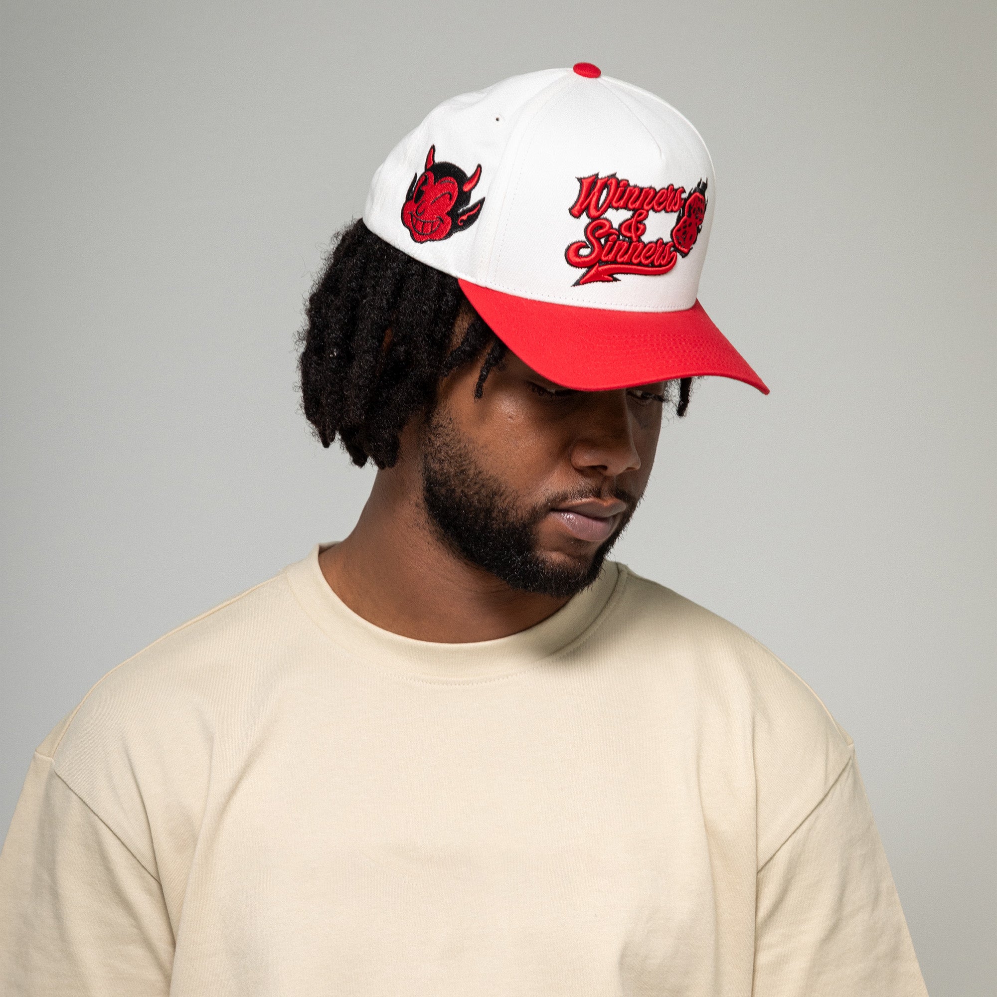 WINNERS AND SINNERS OFF WHITE VARSITY RED TWILL TRUCKER