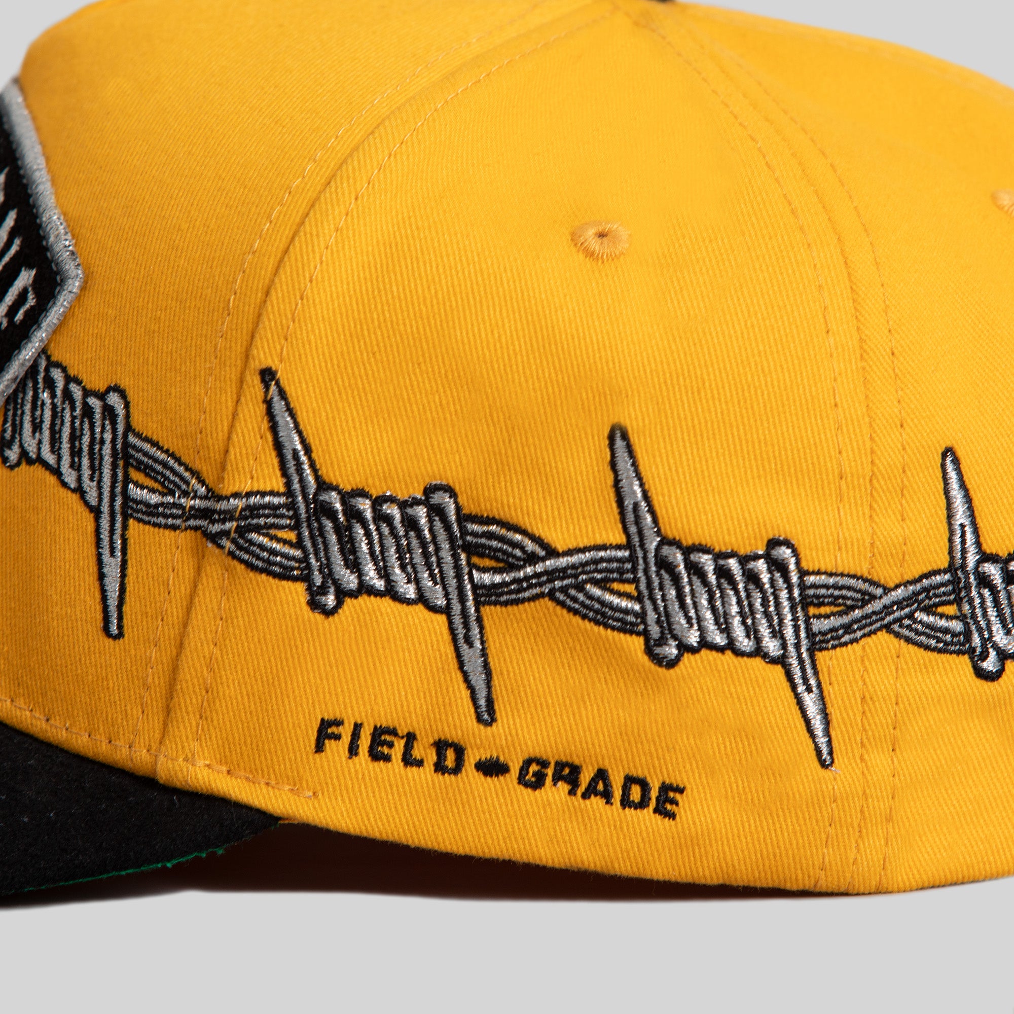 BORN ALONE BARBED WIRE GOLD BLACK TWILL SUEDE TRUCKER