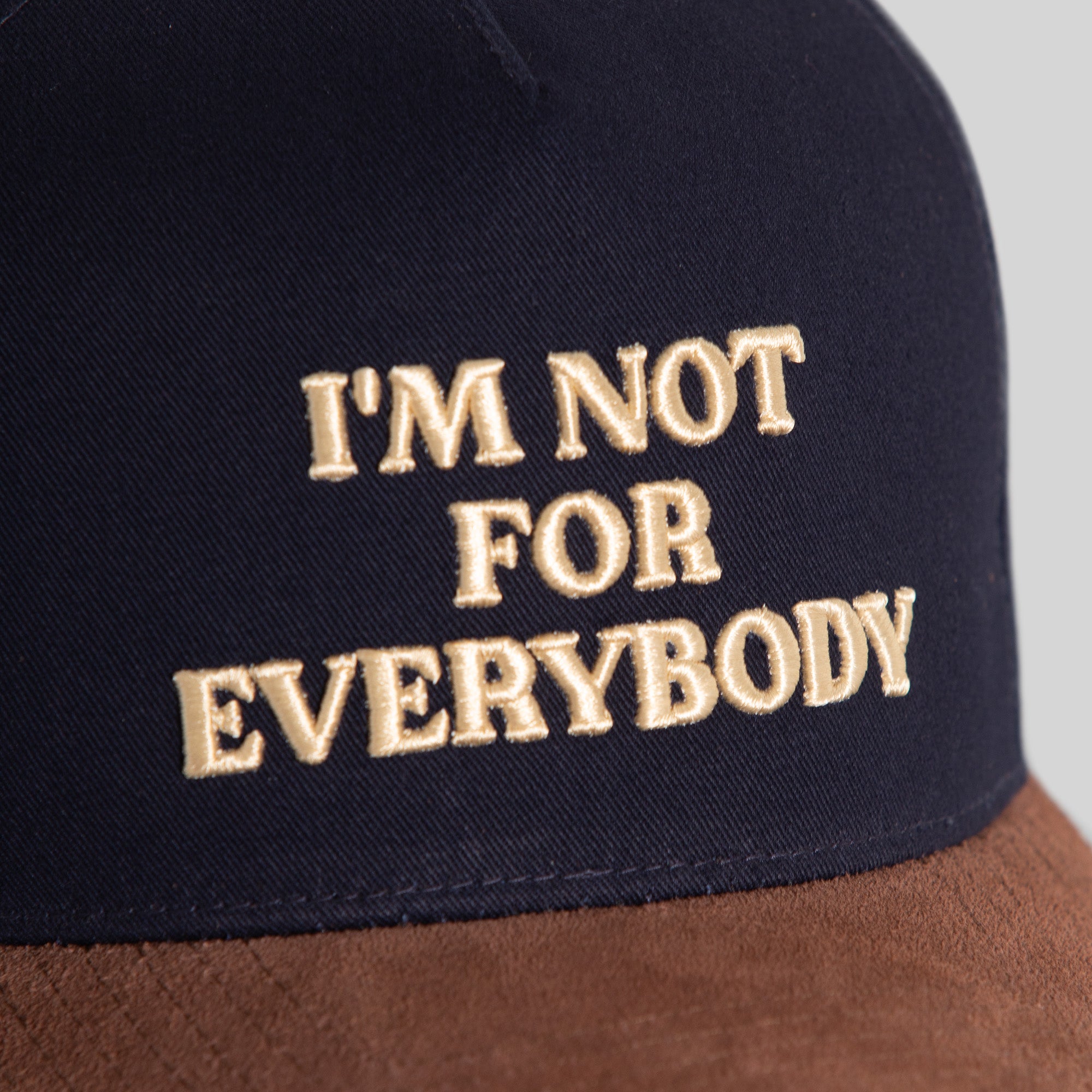 I'M NOT FOR EVERYBODY NAVY MOCHA TWILL SUEDE TRUCKER