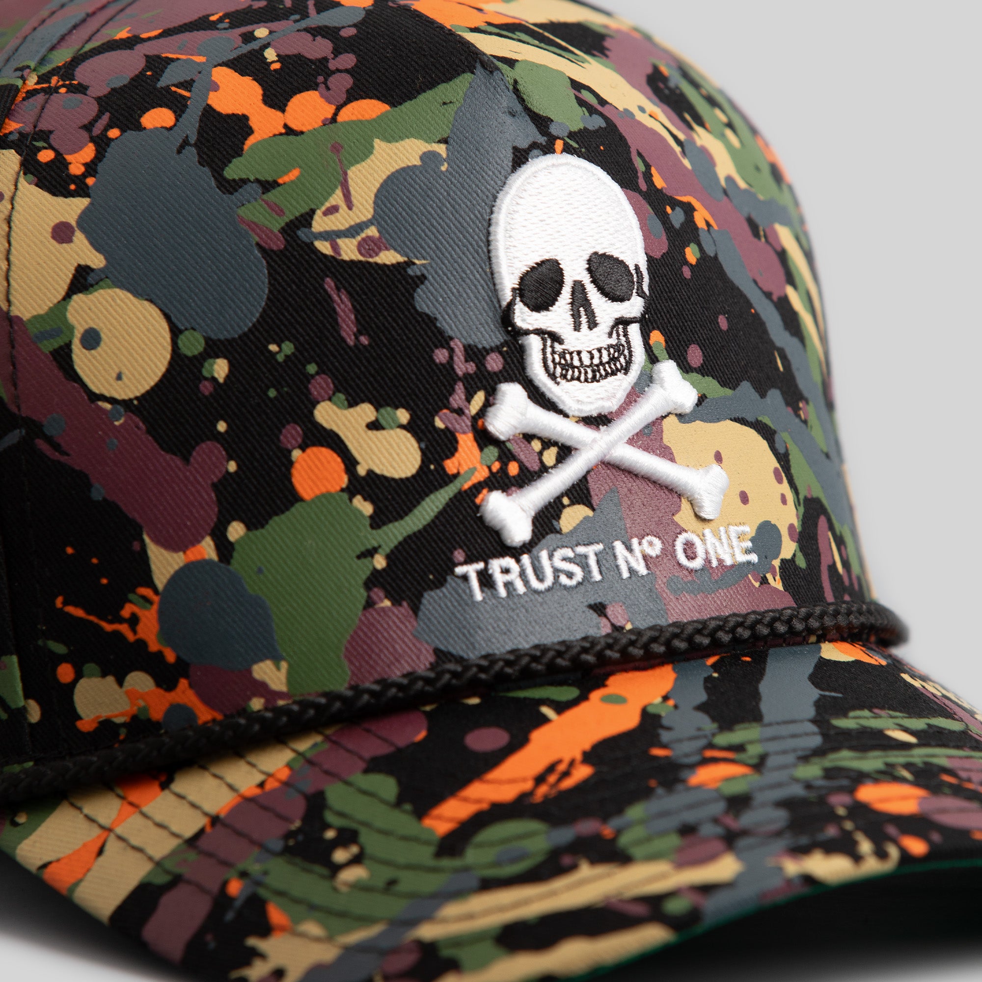 TRUST NO ONE BLACK SPLATTER TRUCKER HAT