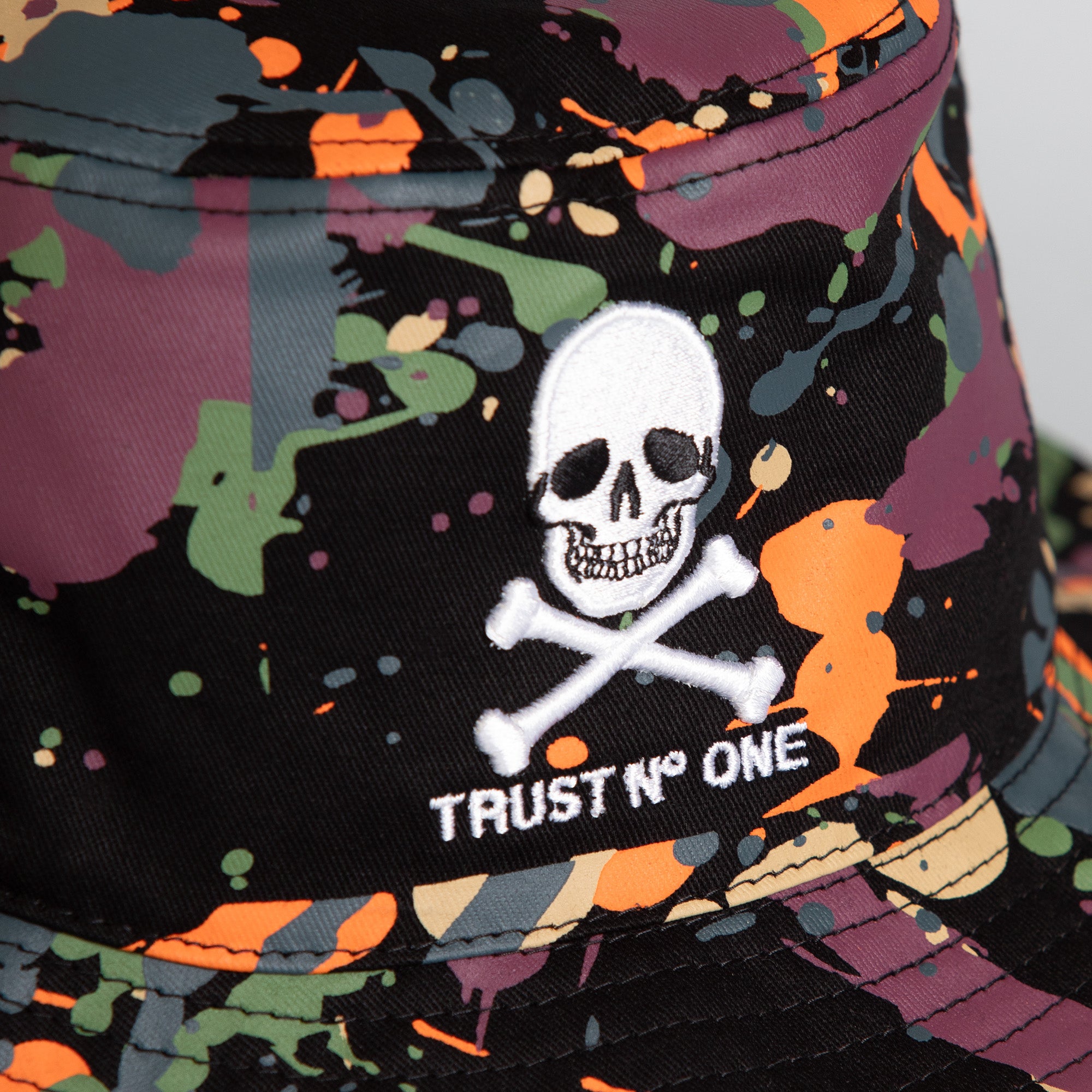 TRUST NO ONE BLACK SPLATTER BUCKET HAT