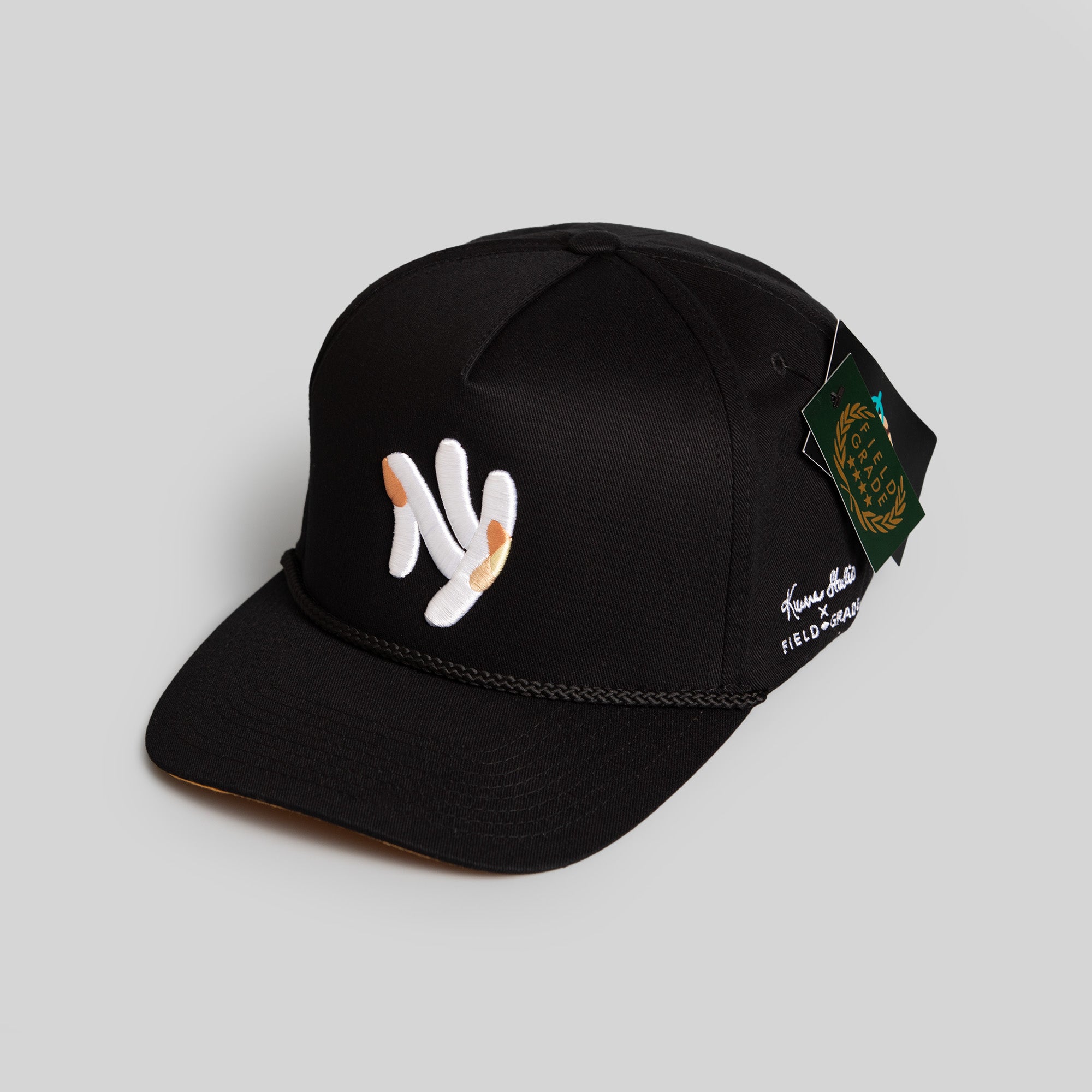 FIELD GRADE X KURVE STUDIO NY IS HEALING BLACK TRUCKER HAT