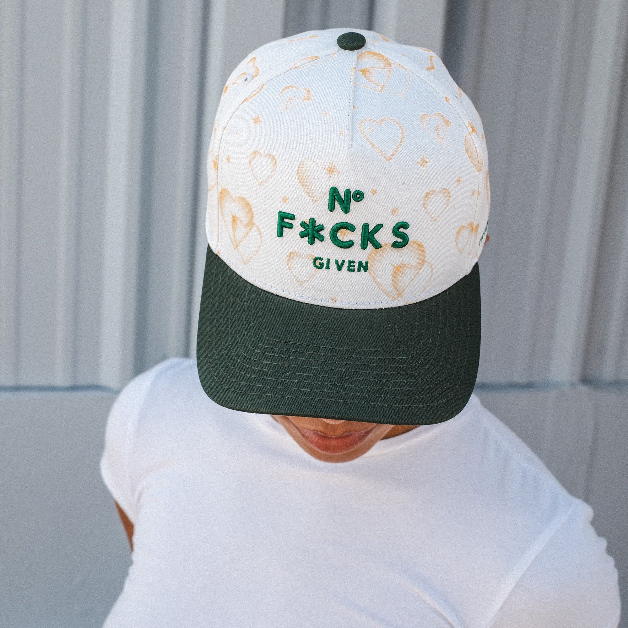 NO F*CKS GIVEN MAJESTIC HEARTS OFF WHITE EMERALD TWILL TRUCKER