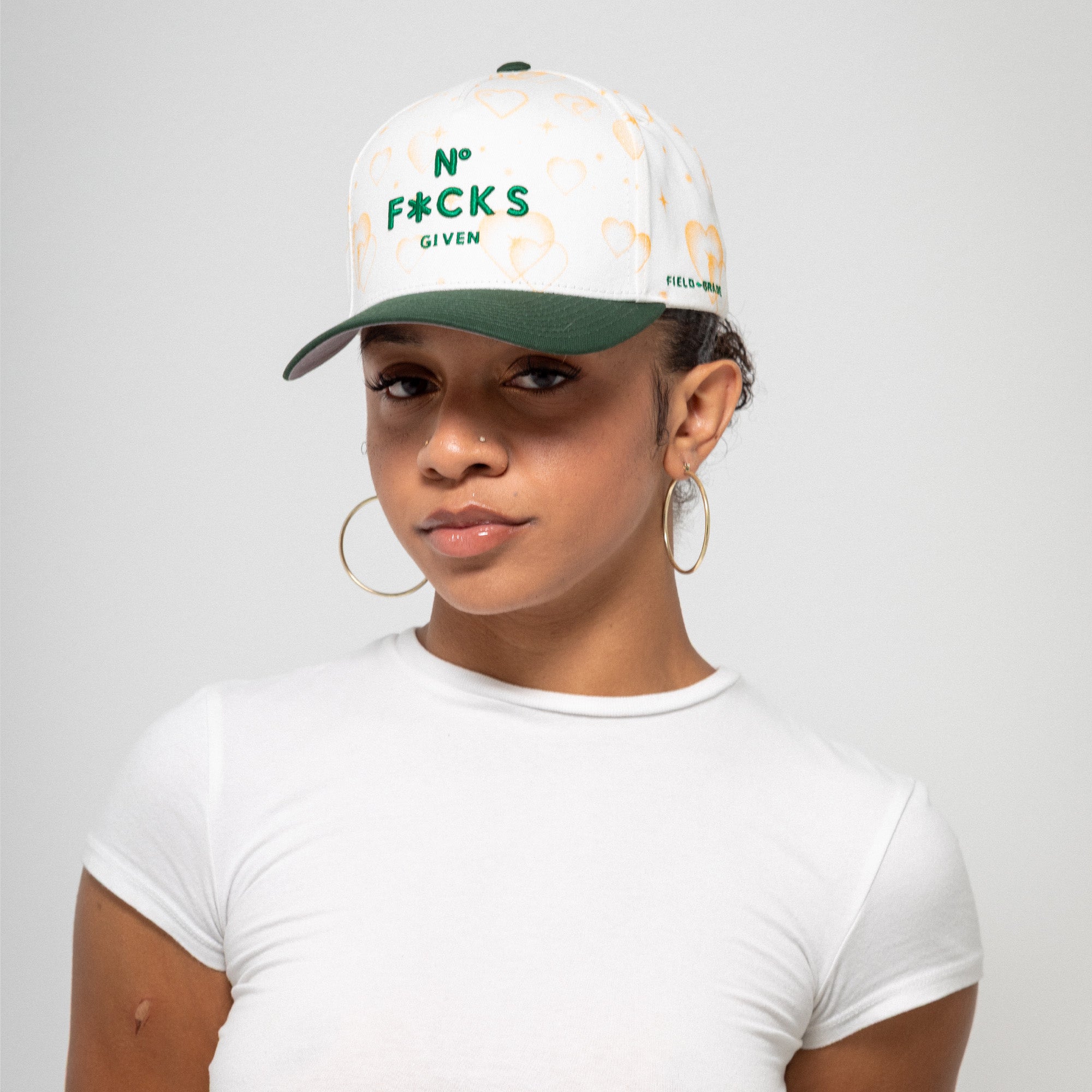 NO F*CKS GIVEN MAJESTIC HEARTS OFF WHITE EMERALD TWILL TRUCKER