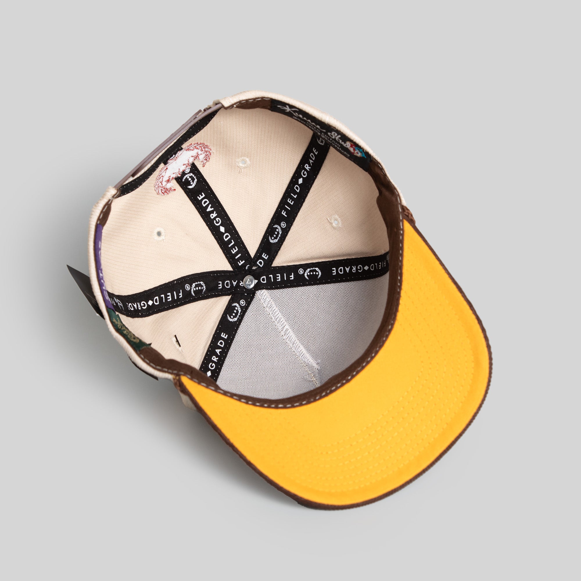 FIELD GRADE X KURVE STUDIO NY IS HEALING STONE/MOCHA TRUCKER HAT