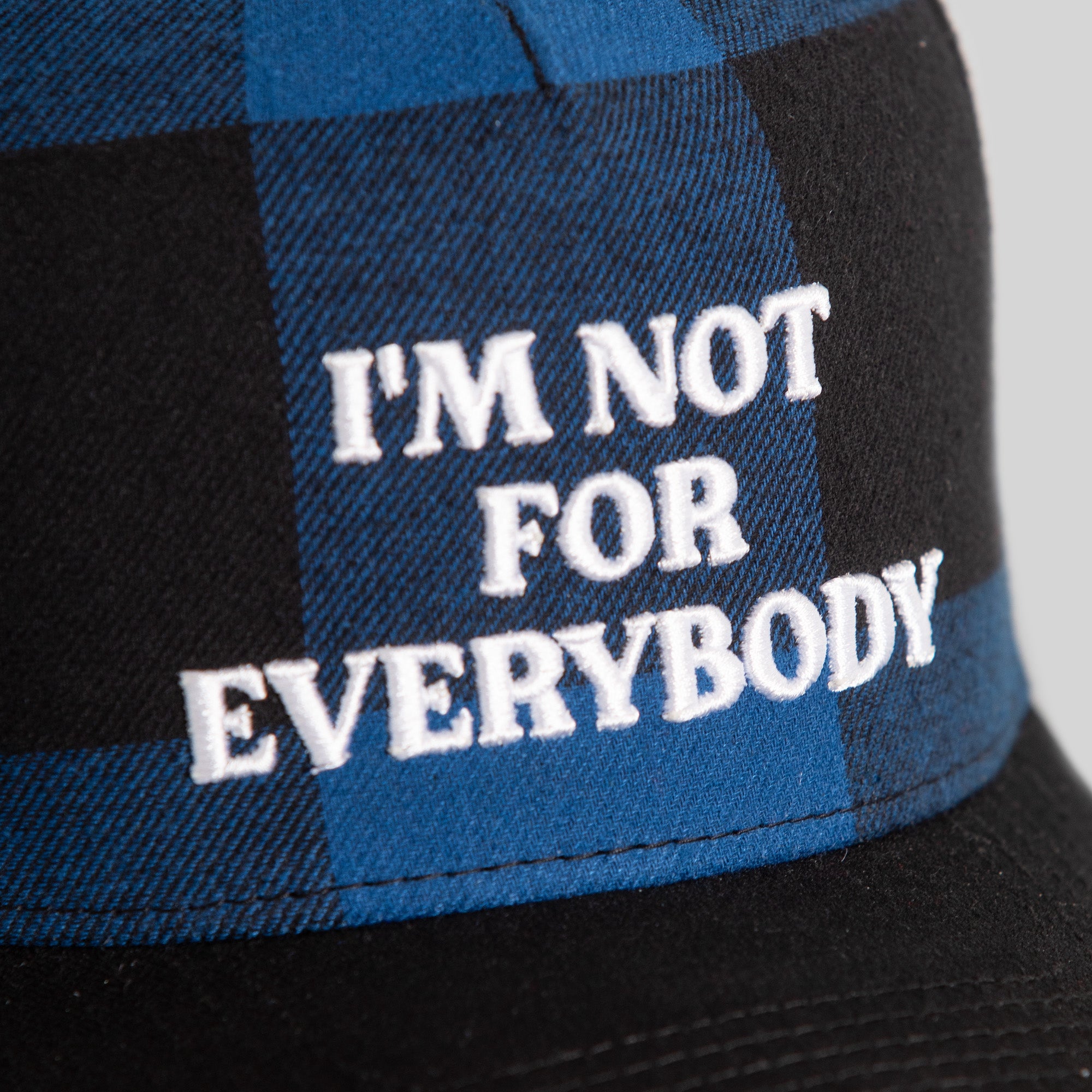 I'M NOT FOR EVERYBODY GAME ROYAL BLACK BUFFALO PLAID TRUCKER