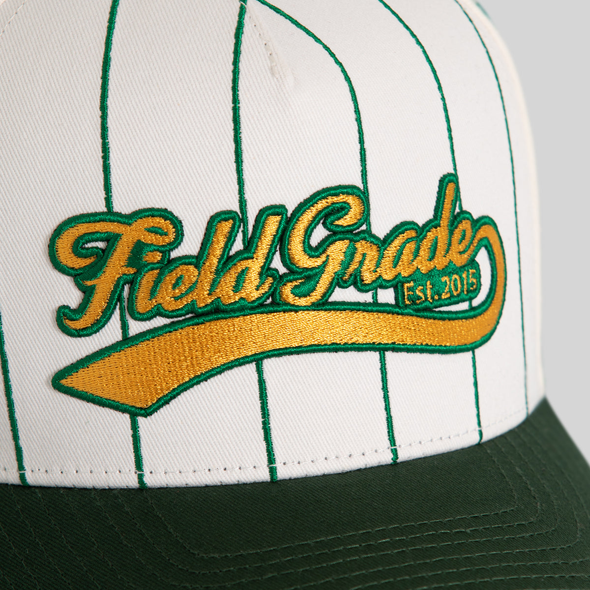 FIELD GRADE COLLEGIATE PINSTRIPE OFF WHITE EMERALD GREEN TWILL TRUCKER