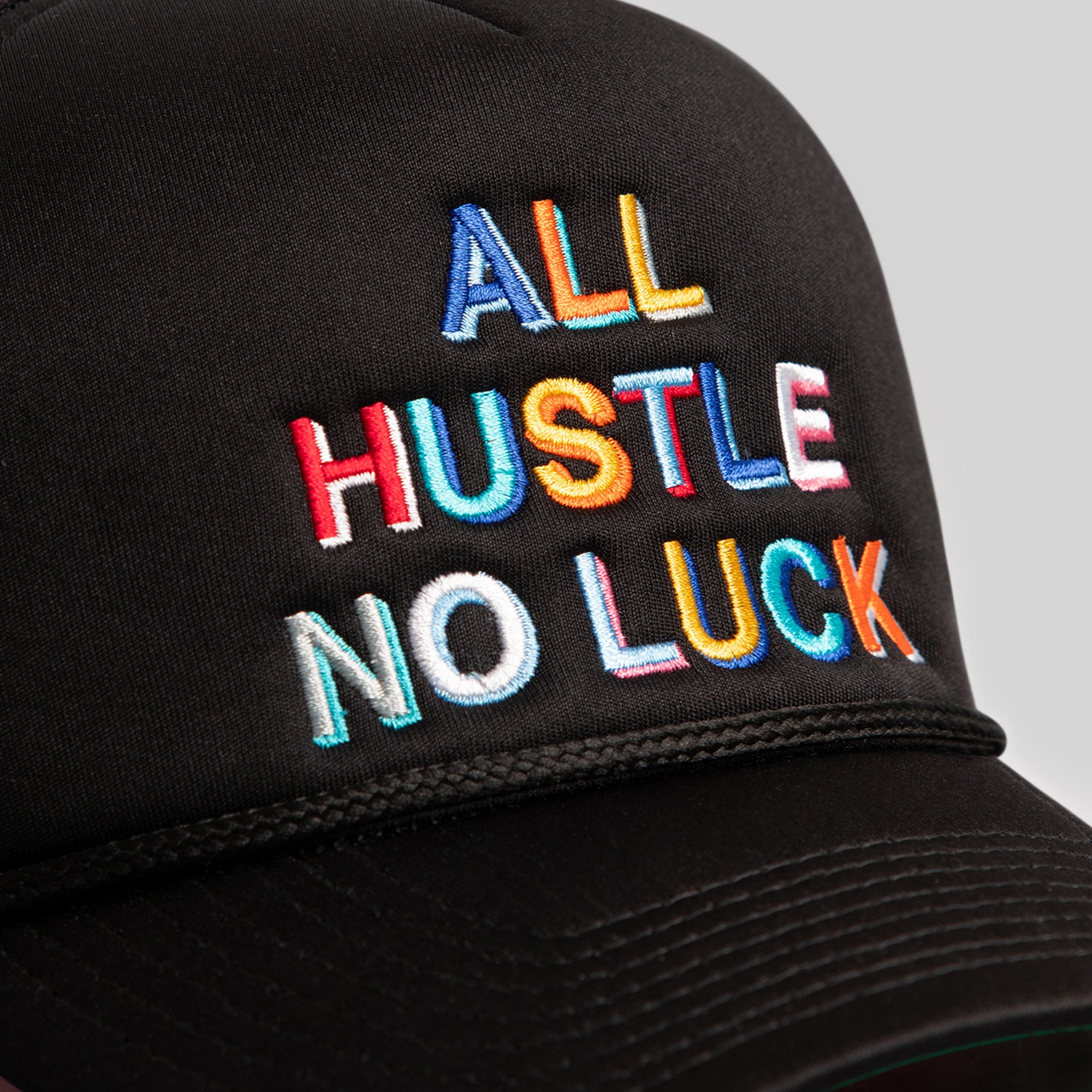 ALL HUSTLE NO LUCK BLACK TRUCKER HAT