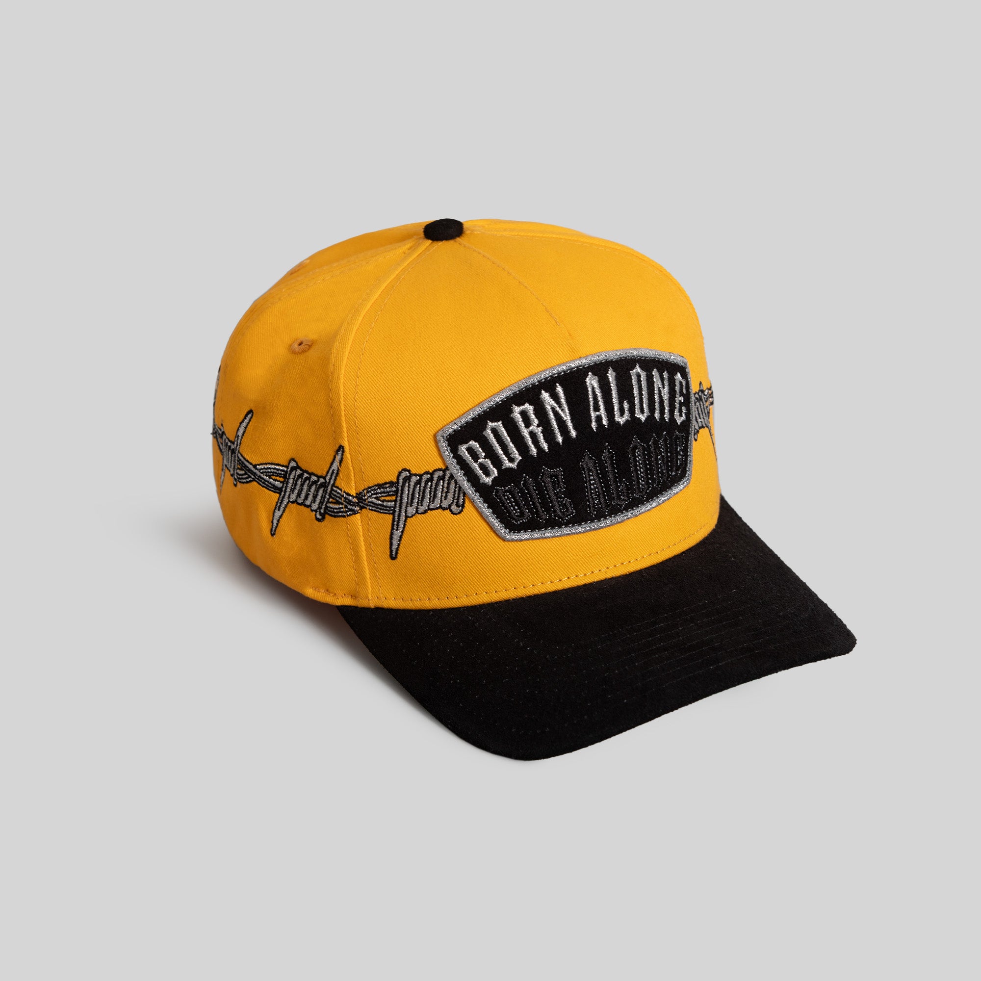 BORN ALONE BARBED WIRE GOLD BLACK TWILL SUEDE TRUCKER