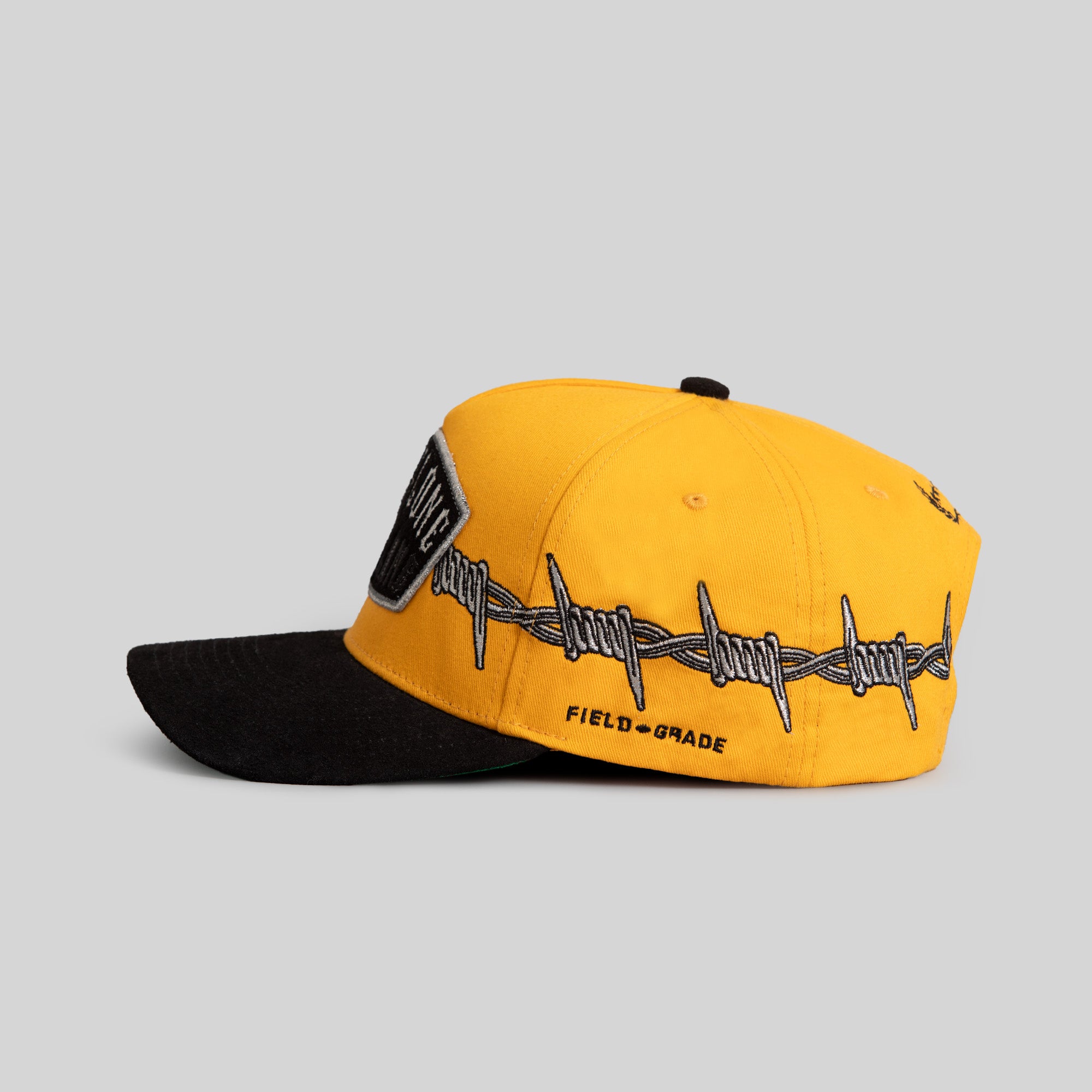 BORN ALONE BARBED WIRE GOLD BLACK TWILL SUEDE TRUCKER