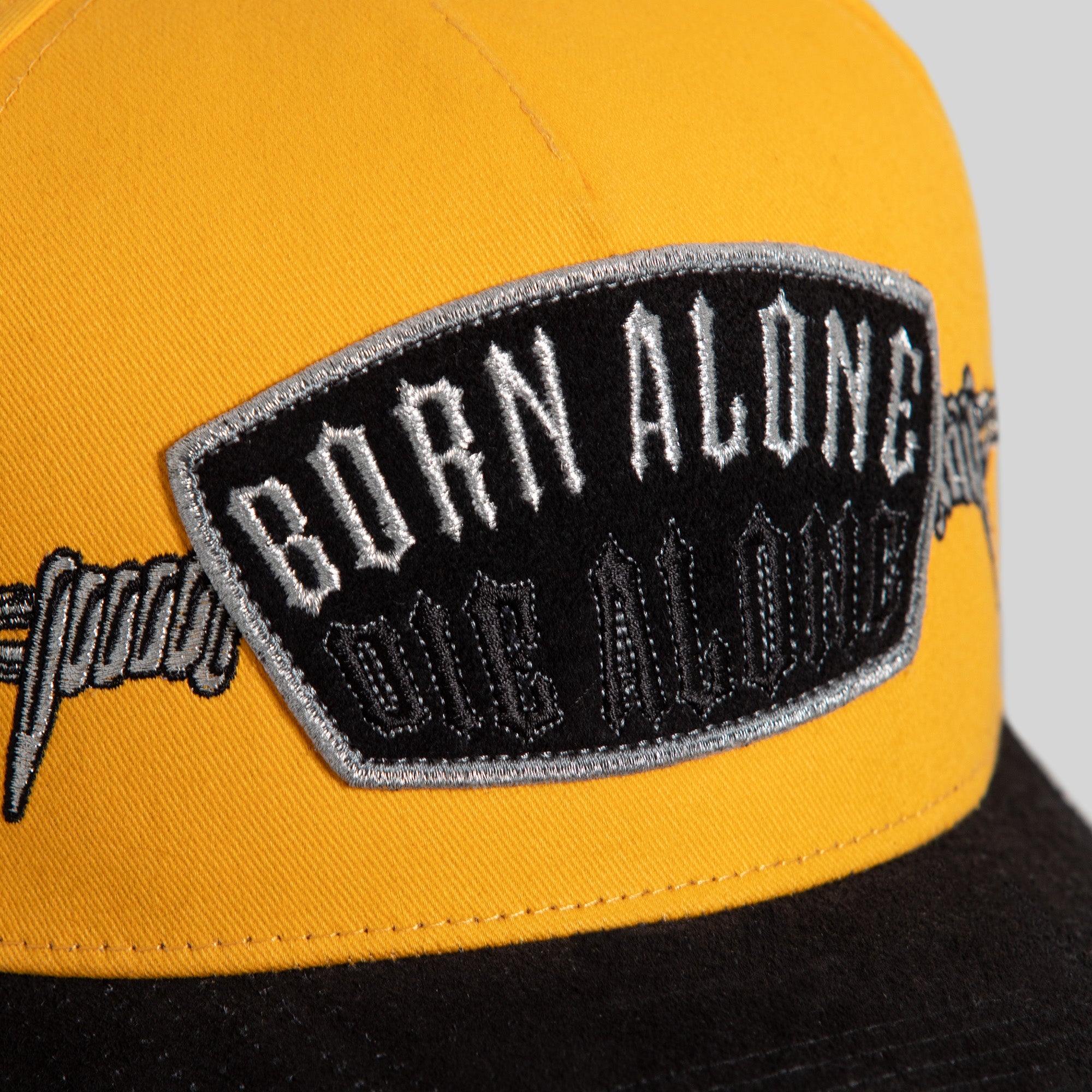 BORN ALONE BARBED WIRE GOLD BLACK TWILL SUEDE TRUCKER